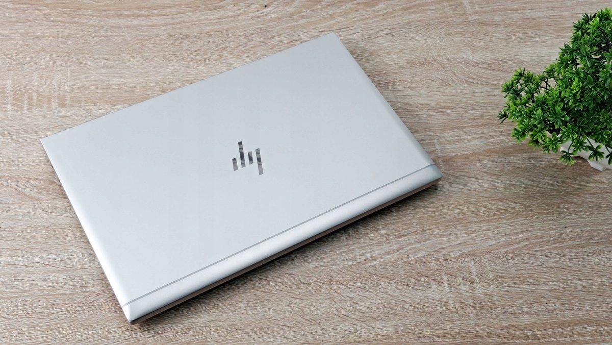 Zamknięty laptop HP EliteBook w srebrnej obudowie, widok z góry pod kątem, obudowa z drobnymi śladami użytkowania.