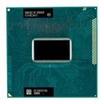 Zbliżenie procesora Intel Core i7-3540M od spodu, widoczne złote pady mostka PGA i zielona płytka podłoża.