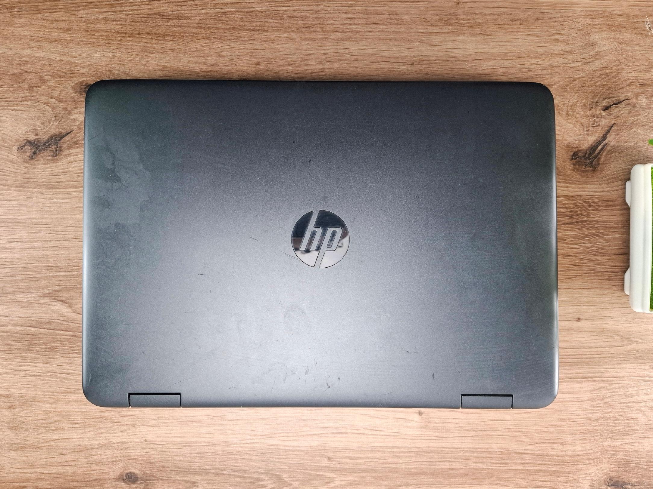 Zamknięty laptop HP ProBook widziany od góry, obudowa z widocznymi zarysowaniami i logo HP na środku klapy.