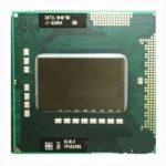 Procesor Intel Core i7-820QM widziany z góry, zielona płytka ze złotymi stykami i czarnym rdzeniem pośrodku.