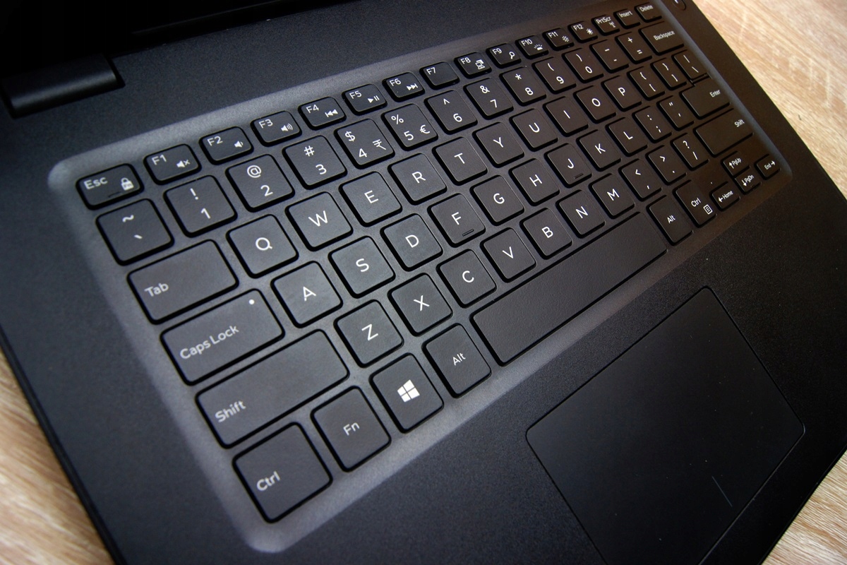Zbliżenie na klawiaturę laptopa Dell Latitude z gładzikiem, obudowa czarna z widocznymi śladami użytkowania.