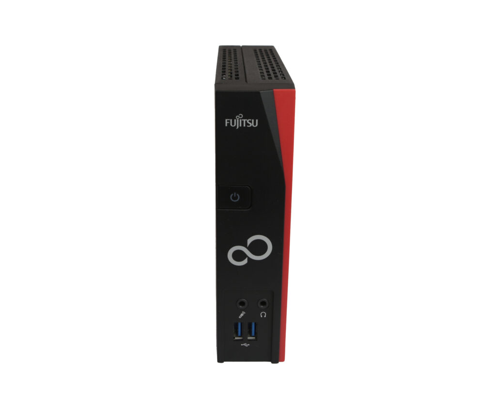 Thin client Fujitsu Futro S520 w pionowej pozycji, widok z przodu z portami audio i USB oraz logo Fujitsu na obudowie.