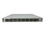 Przedni panel switcha Brocade z rzędami portów SFP/QSFP w białej obudowie rack, widoczne dwa zasilacze po prawej.