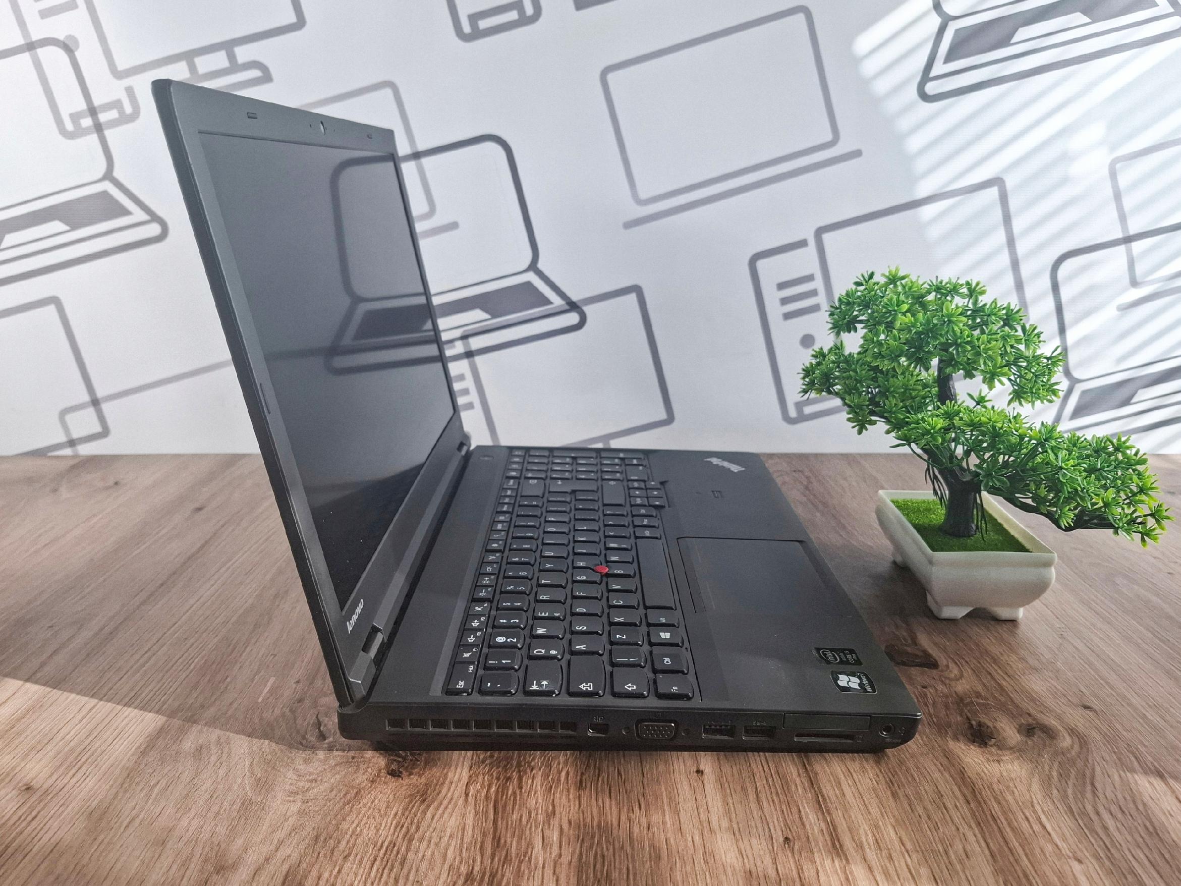 Laptop Lenovo ThinkPad T540p uchylony bokiem, widoczna klawiatura, wygaszony ekran i prawa krawędź z portami.