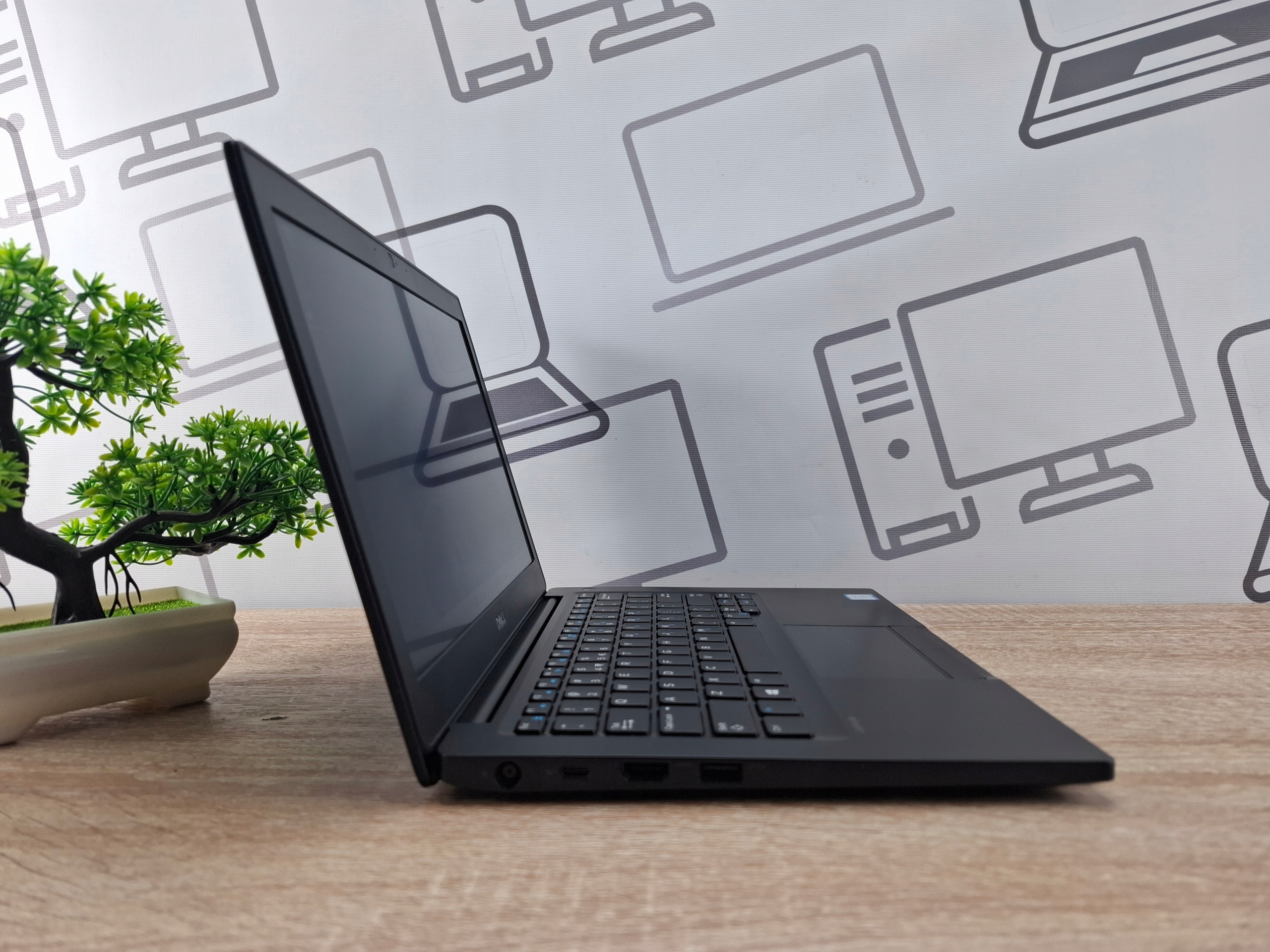 Laptop Dell Latitude 7280 otwarty pod kątem z boku, widoczny profil klawiatury i ekranu, obudowa w dobrym stanie.