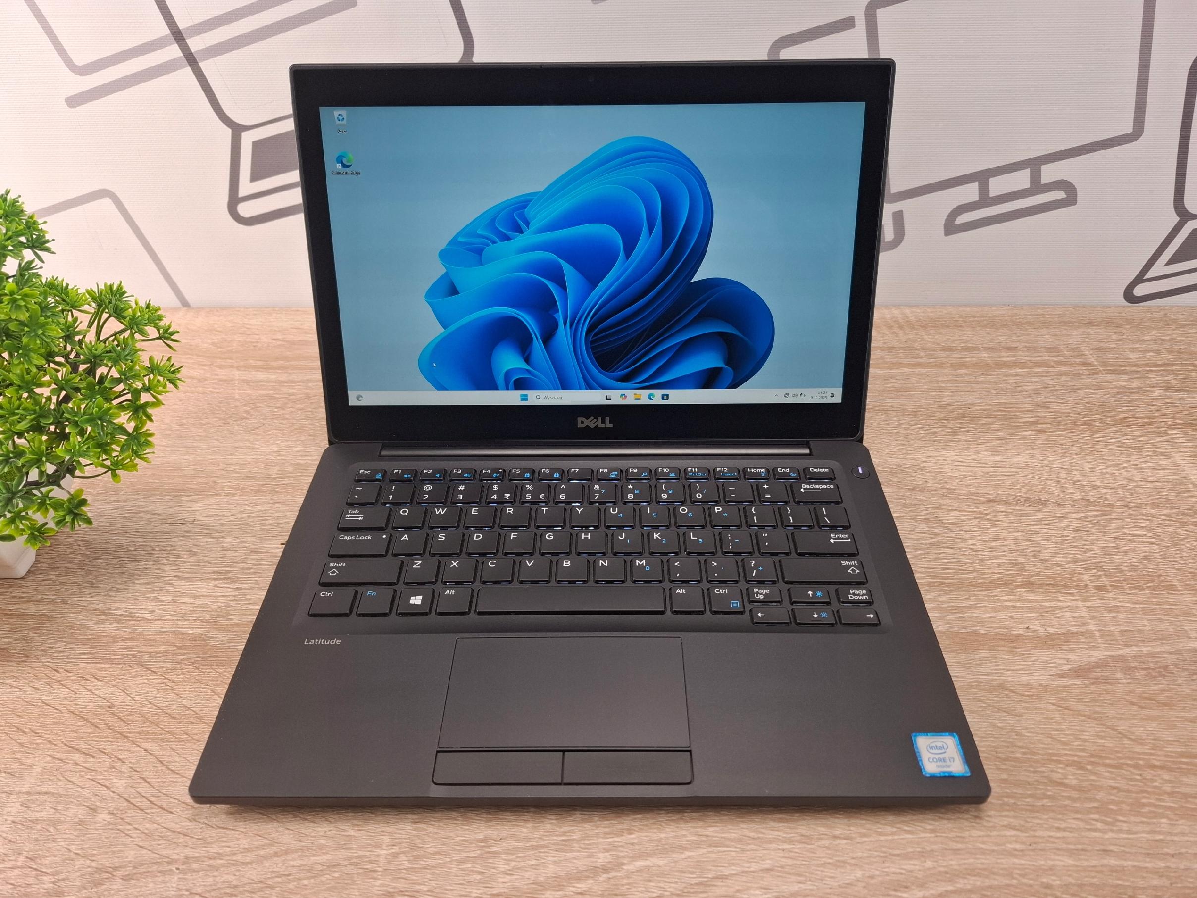 Otwarty laptop Dell Latitude 7280 widziany od przodu, na ekranie logo Windows 11, klawiatura w dobrym stanie.