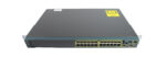 Przedni panel switcha Cisco z 24 portami RJ45, dwoma slotami SFP i rzędami diod stanu, obudowa z uszami montażowymi.