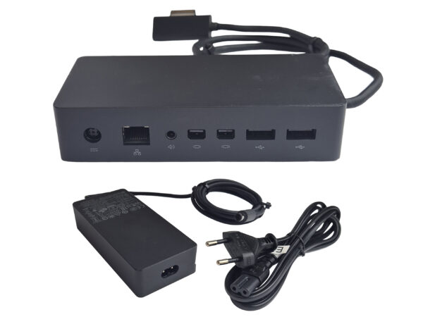 Stacja dokująca Microsoft Surface Dock z portami LAN, Mini DisplayPort i USB, obok zasilacz z kablem sieciowym.