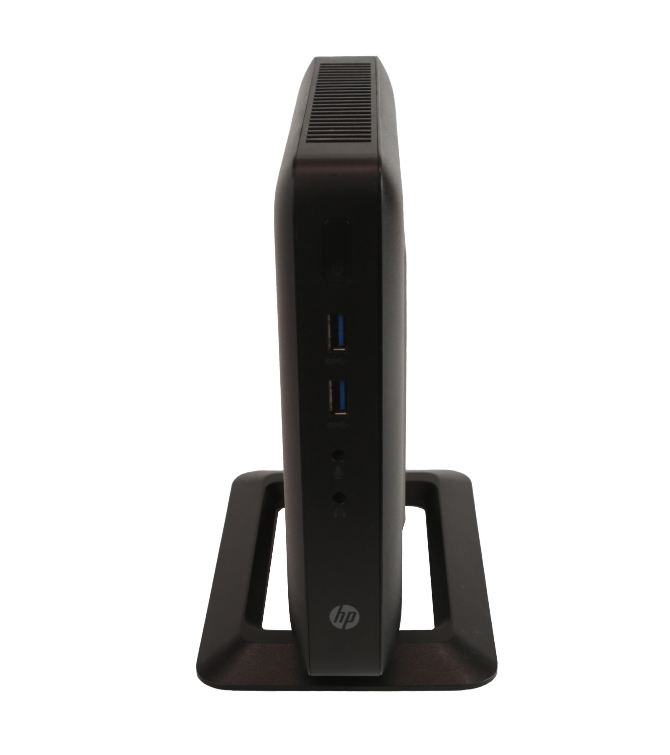 Thin client HP t520 ustawiony pionowo na czarnej podstawce, widok z boku z dwoma portami USB i logo HP.